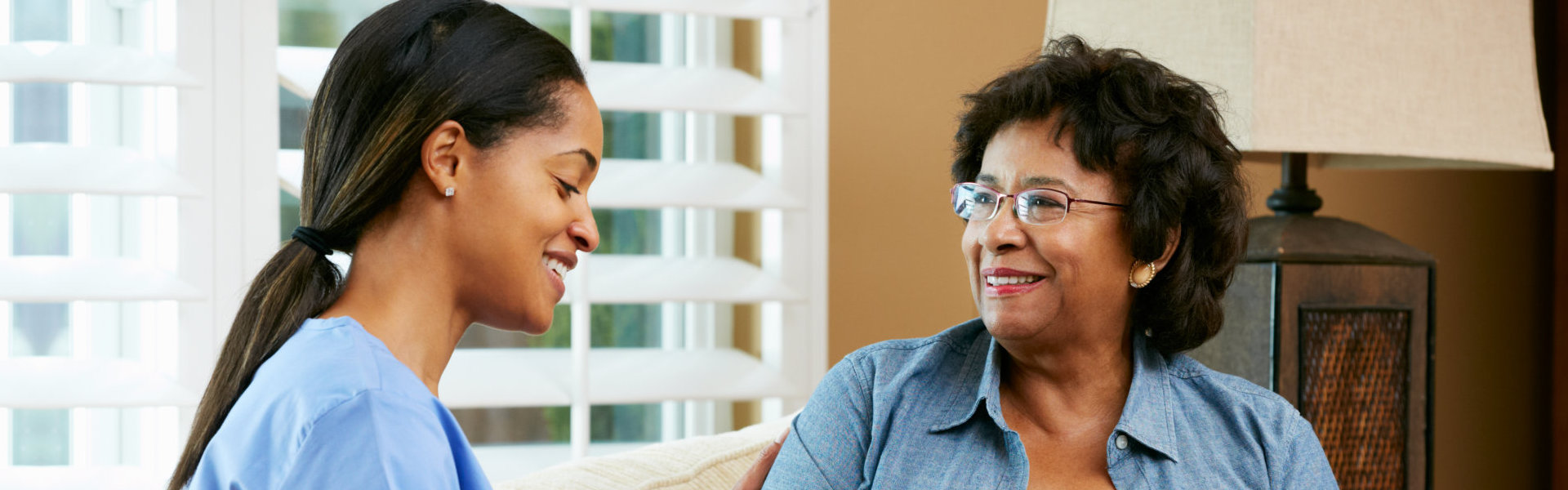 senior woman and a nurse talking