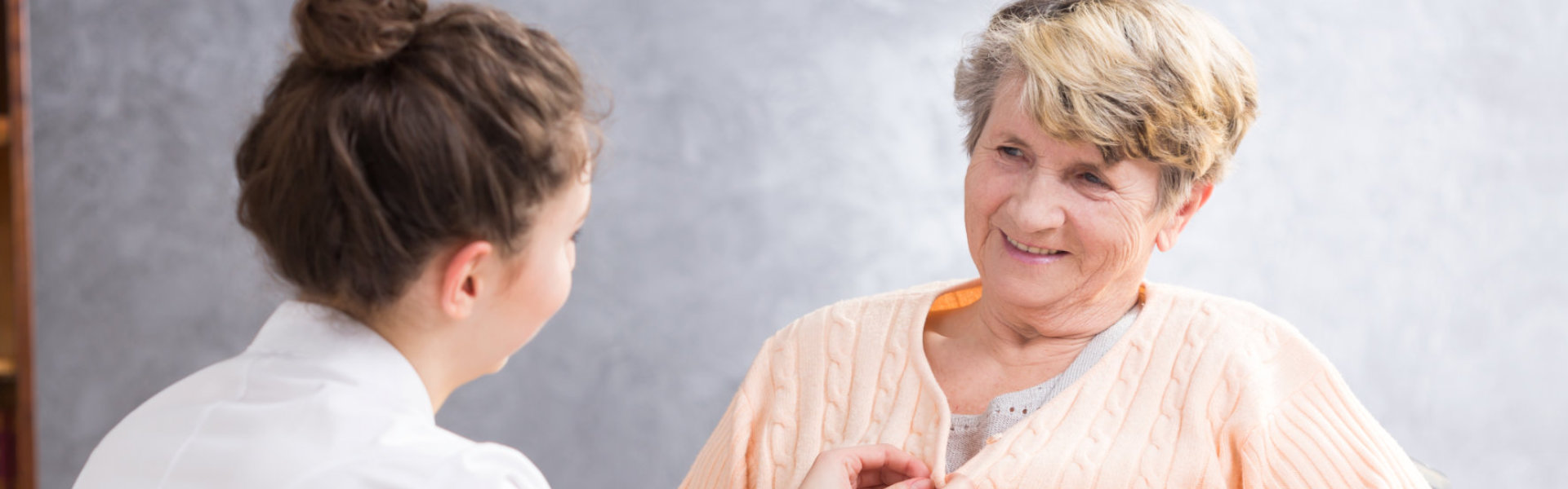 nurse and a senior woman talking